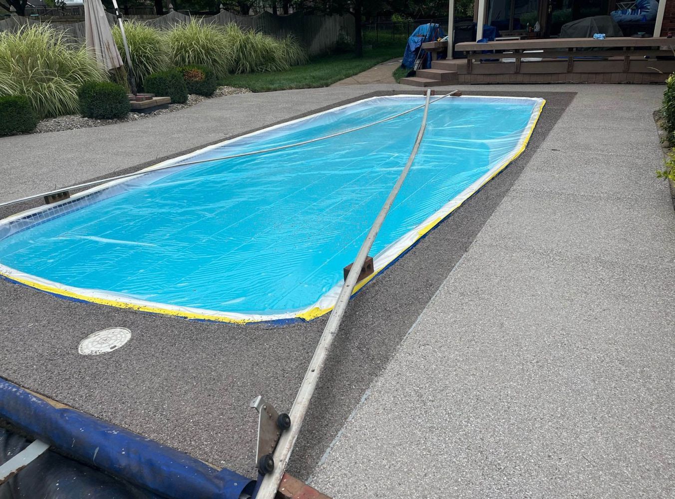 A large swimming pool surrounded by concrete