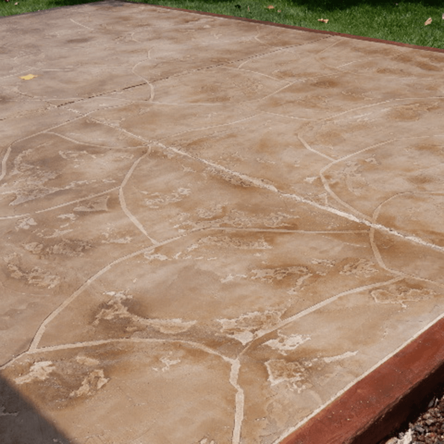 A close up of a stamped concrete patio with a red border.