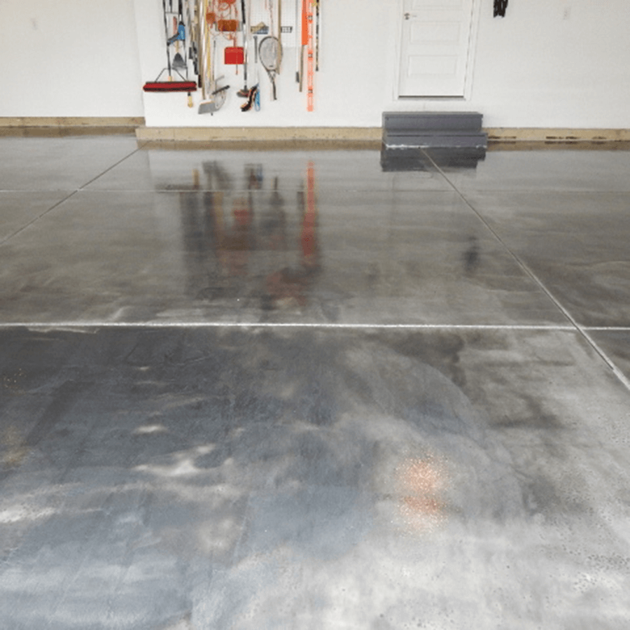 A garage with a lot of tools hanging on the wall and a shiny concrete floor