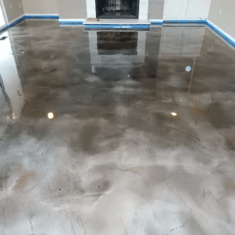 A living room with a shiny concrete floor and a fireplace.