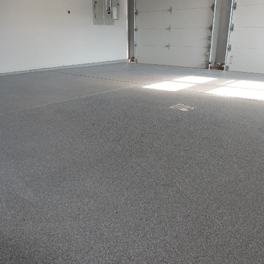 A garage with a concrete floor and a garage door