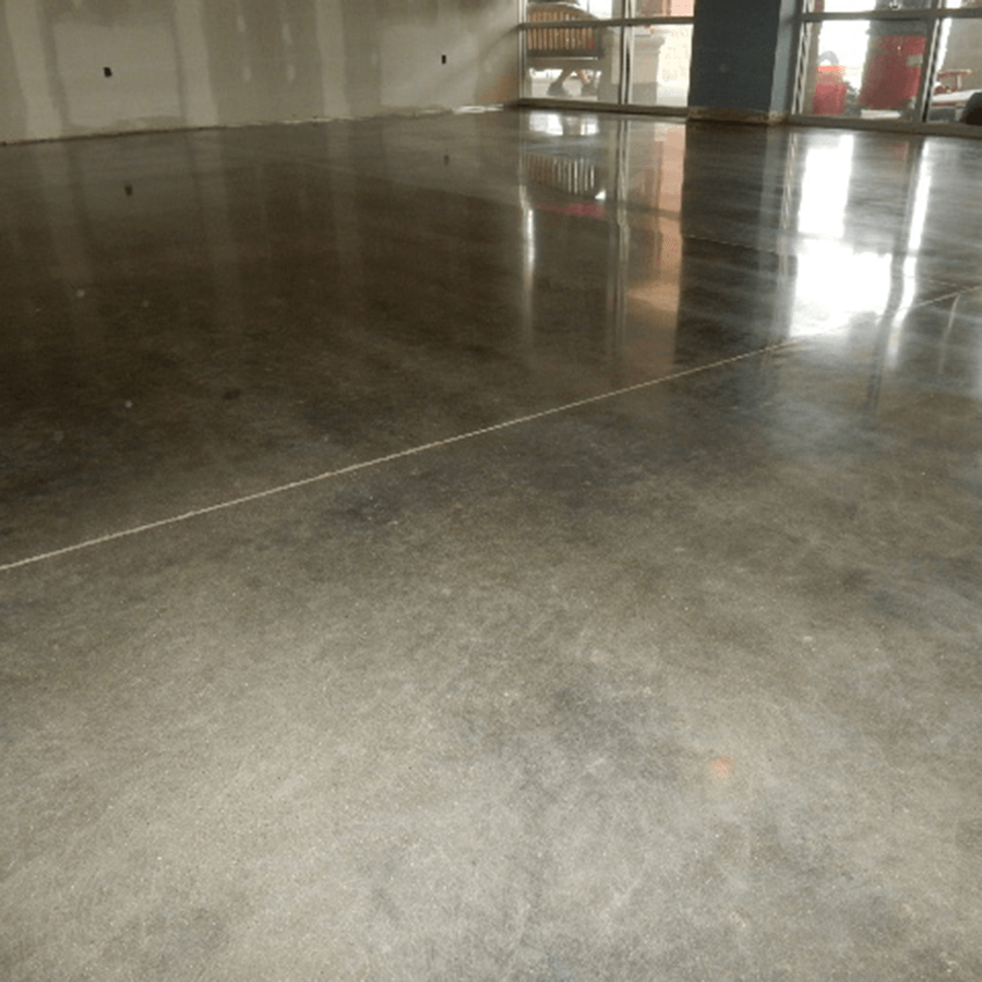 A shiny concrete floor in a room with a window