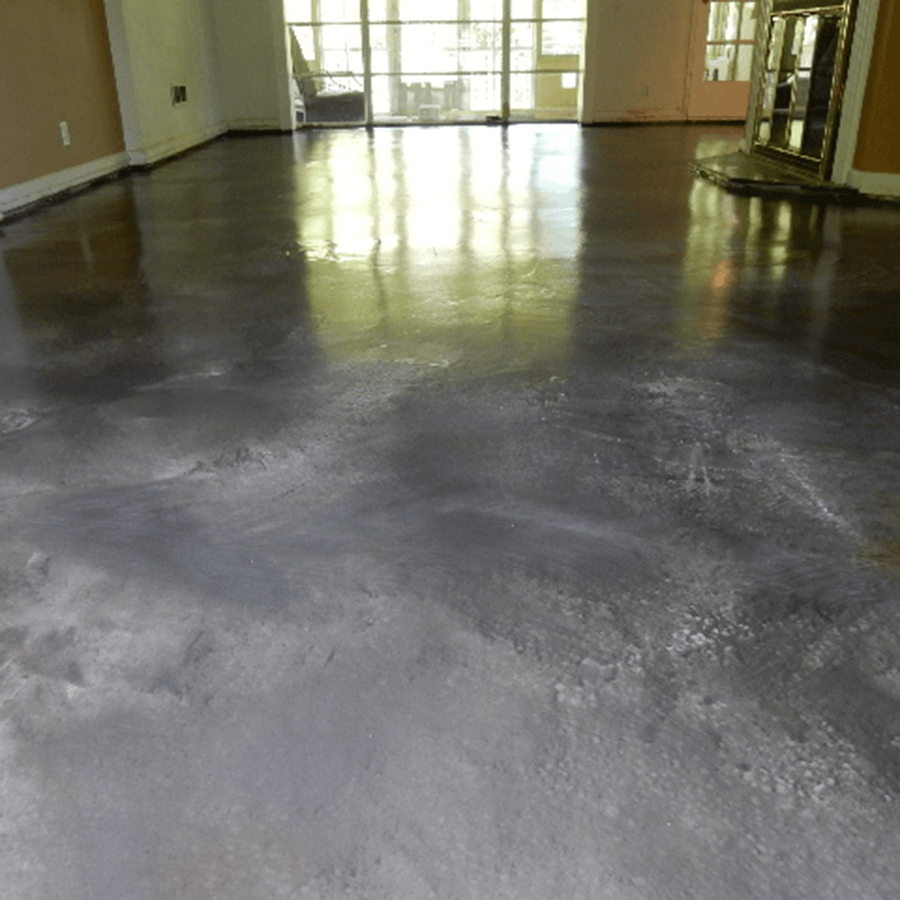 A large room with a concrete floor and a lot of windows