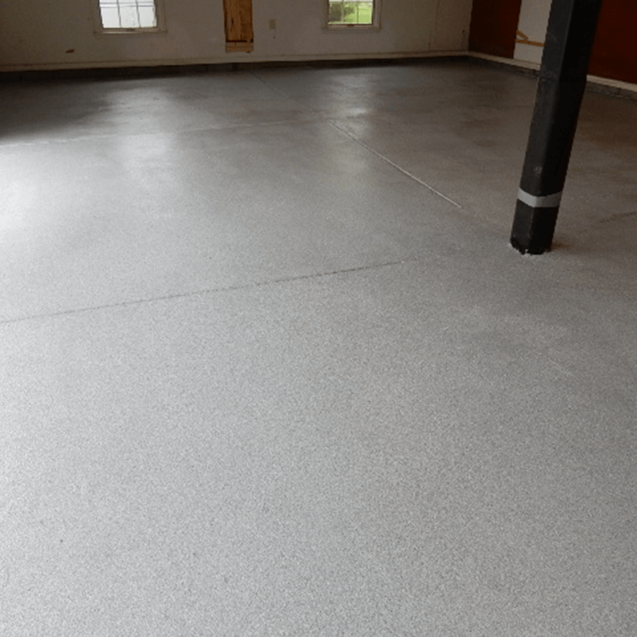 A large empty room with a white floor and a black pole.