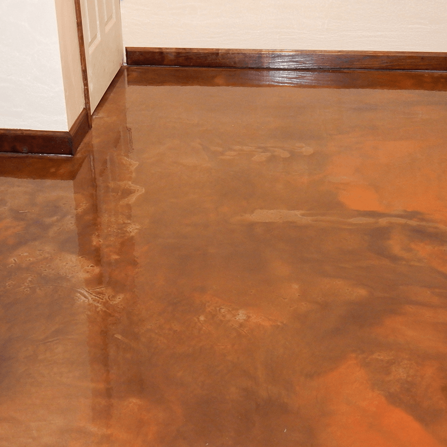 A close up of a copper colored concrete floor in a room.