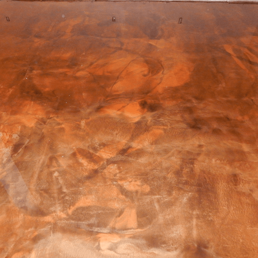A close up of a copper colored concrete floor.