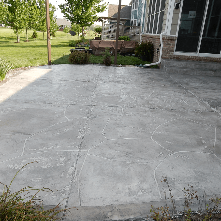 A decorative concrete patio in front of a house