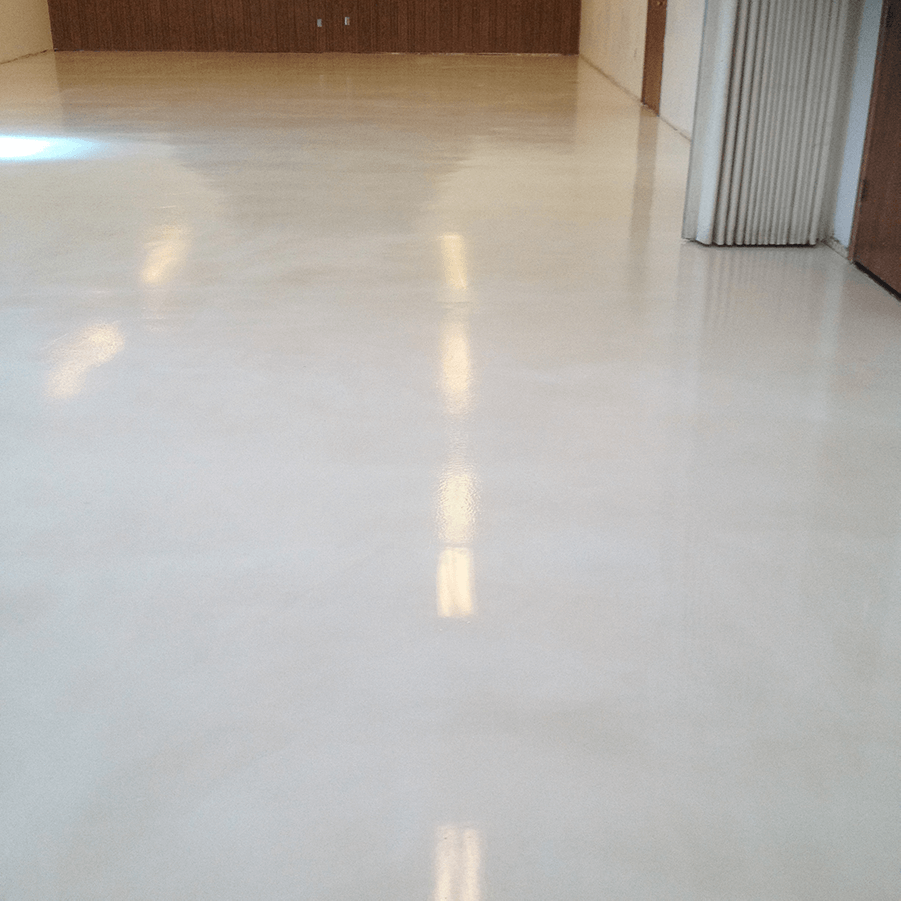 A room with a shiny white floor and a wooden wall.