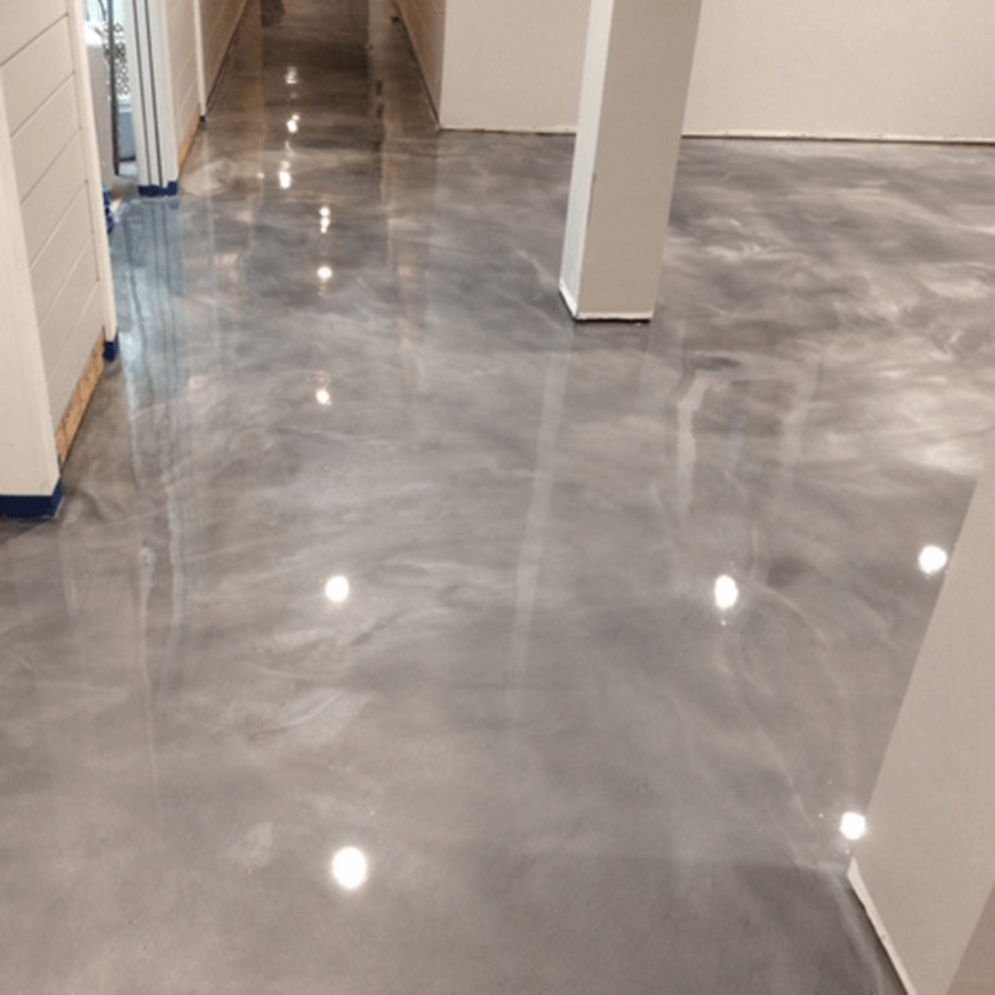 A hallway with a shiny metallic floor and white walls
