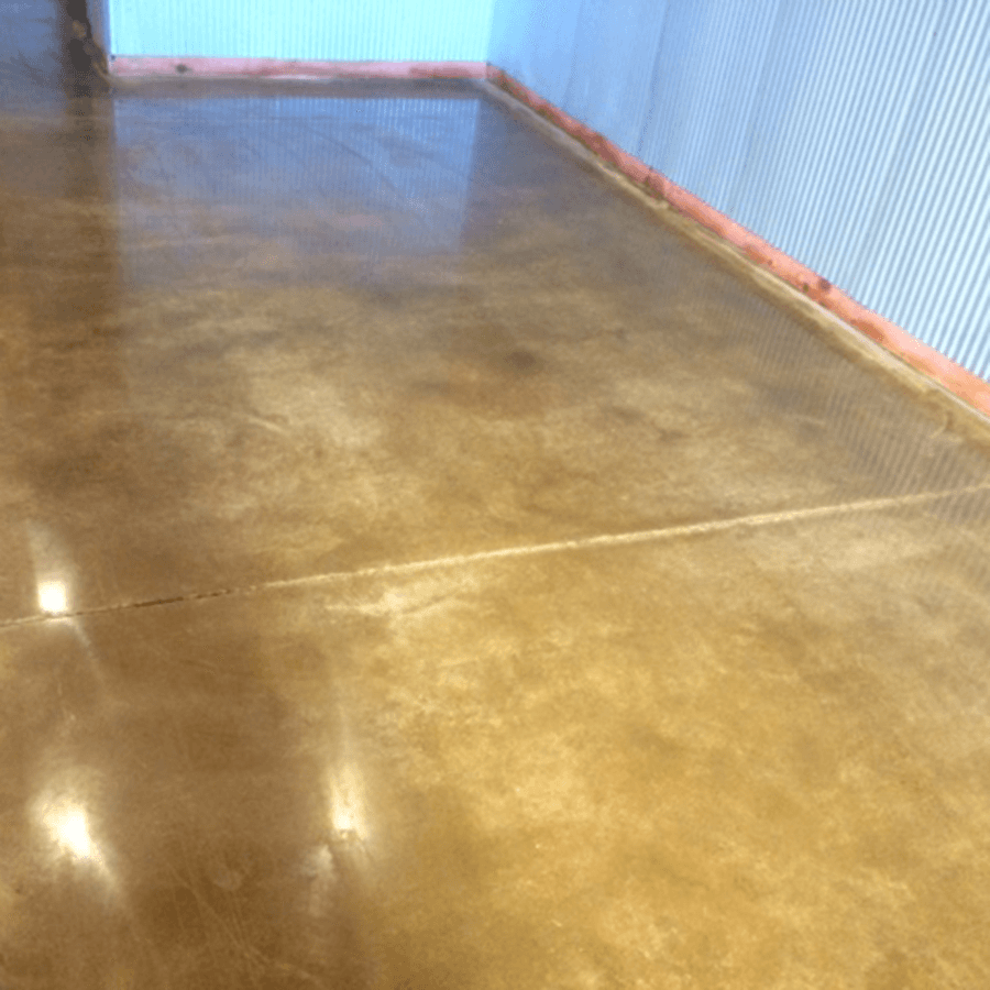 A close up of a shiny concrete floor in a room.
