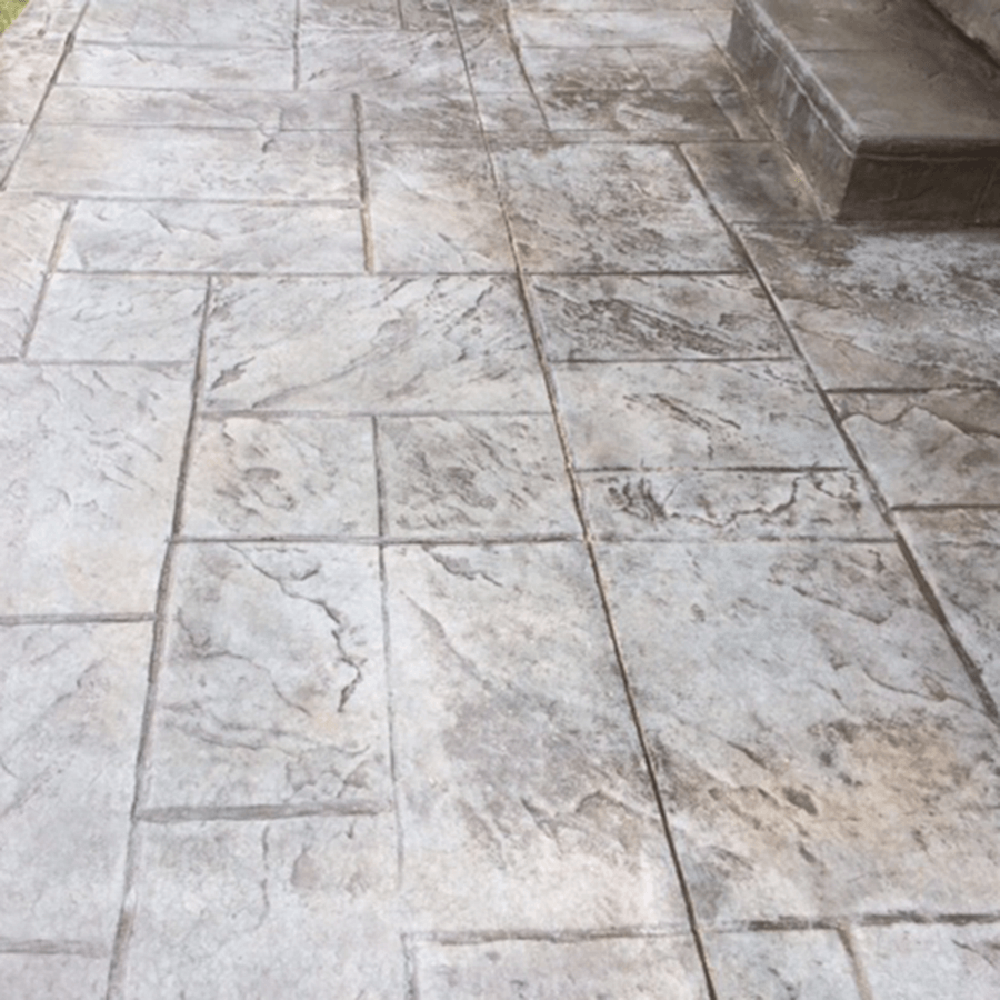 A close up of a decorative concrete walkway with steps.