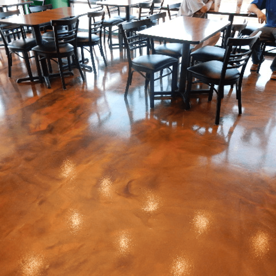 A restaurant with tables and chairs on a wooden floor.