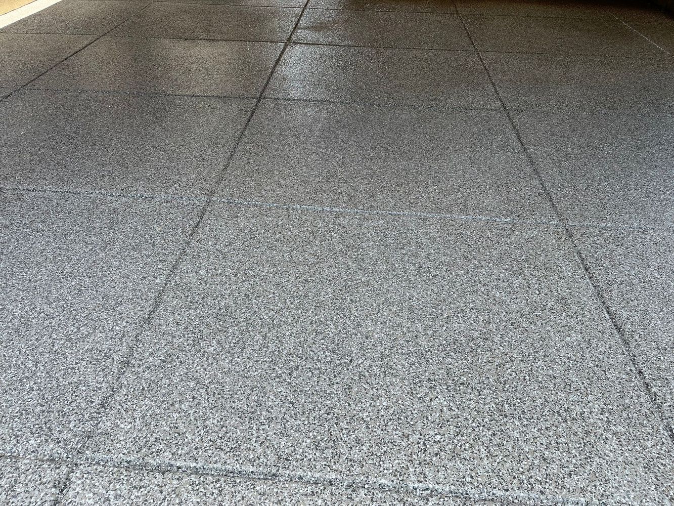 A close up of a concrete floor in a garage.