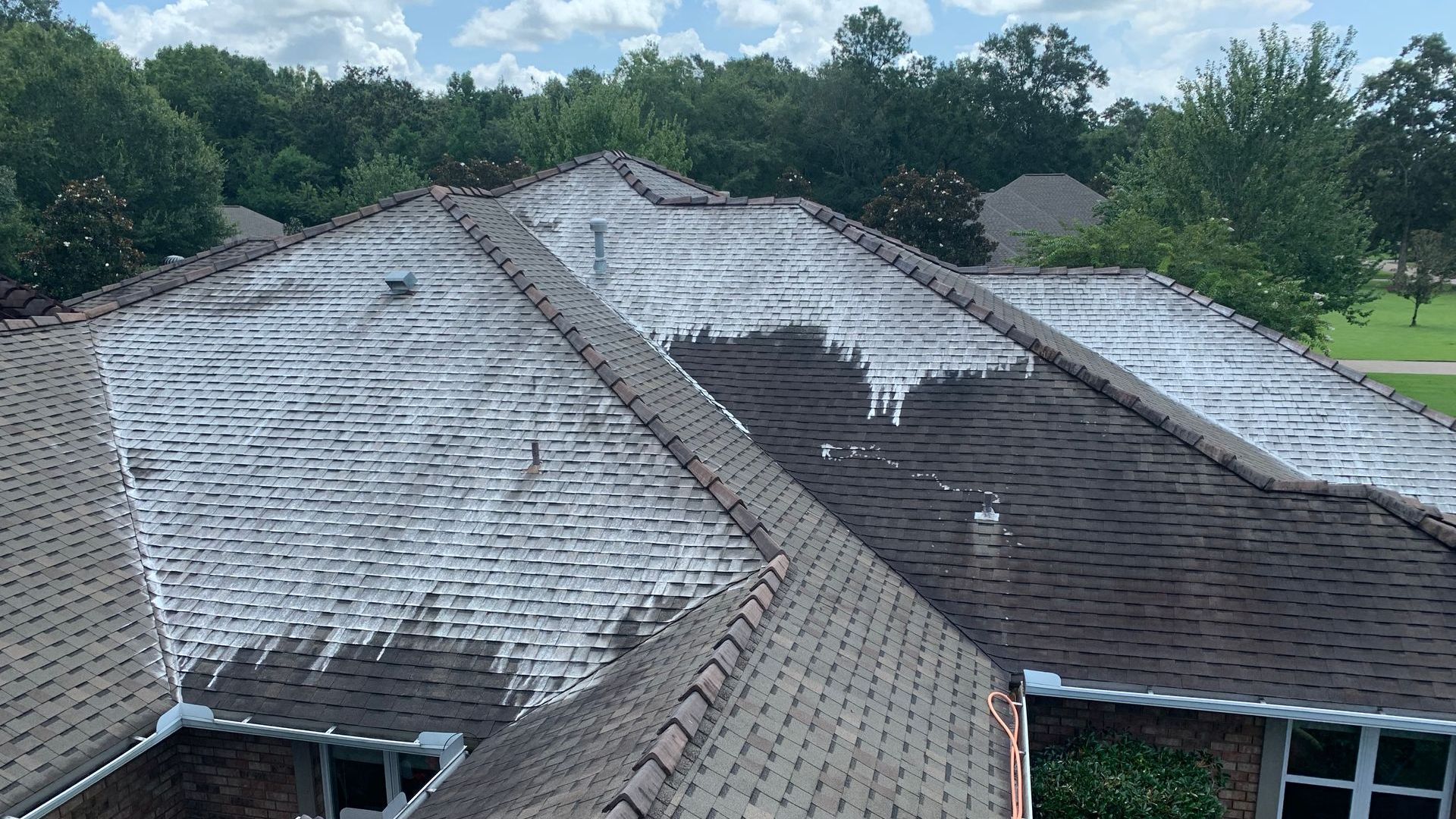 The roof of a house is covered in ice and snow.