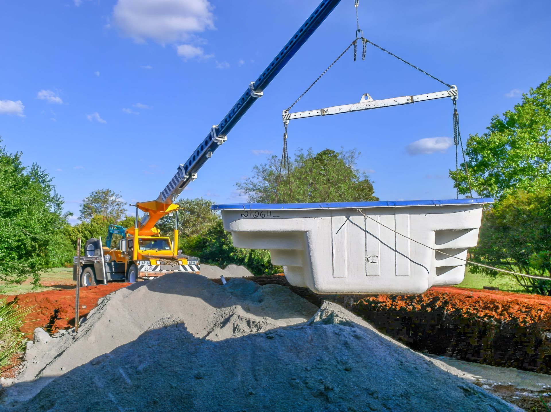 A white truck with a crane attached to the back of it