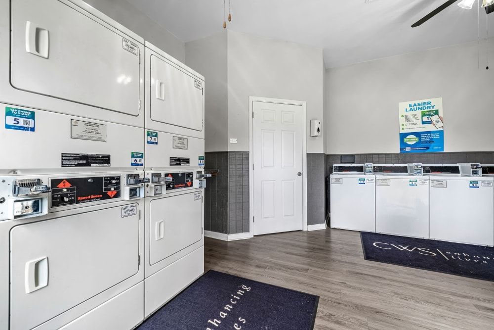 a laundromat with a lot of washers and dryers at The Park at Flower Mound in Flower Mound, TX.