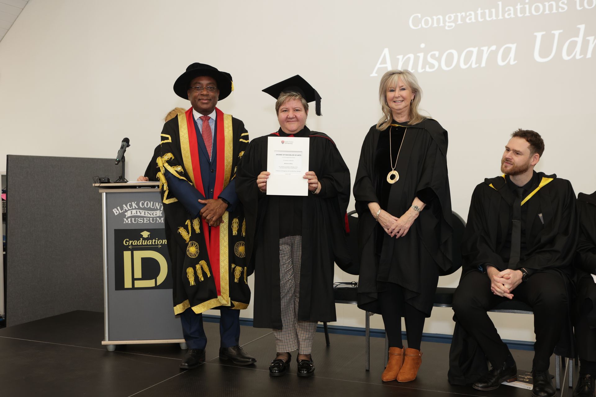 gradation recipients on stage receiving their degrees
