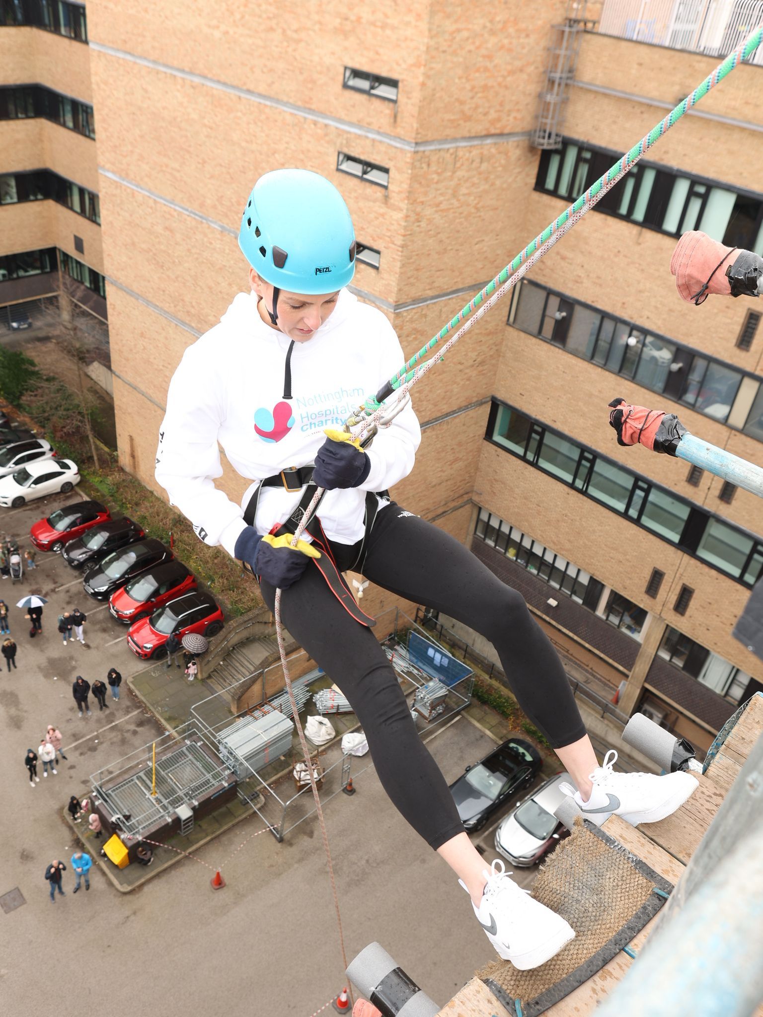 an abseil about to descend down a building