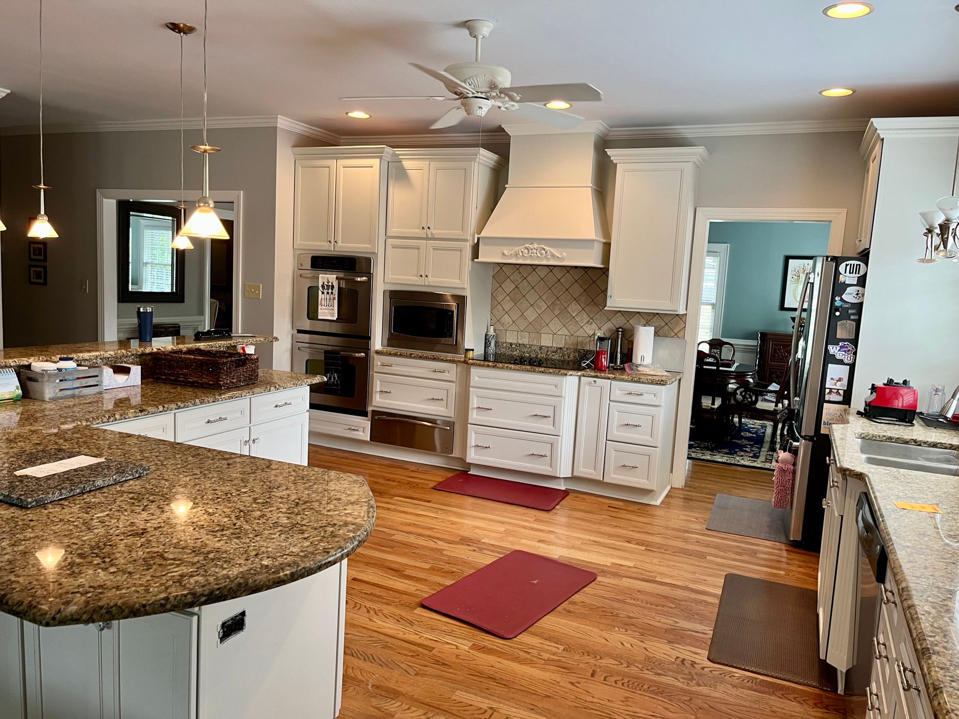A kitchen with white cabinets and granite counter tops