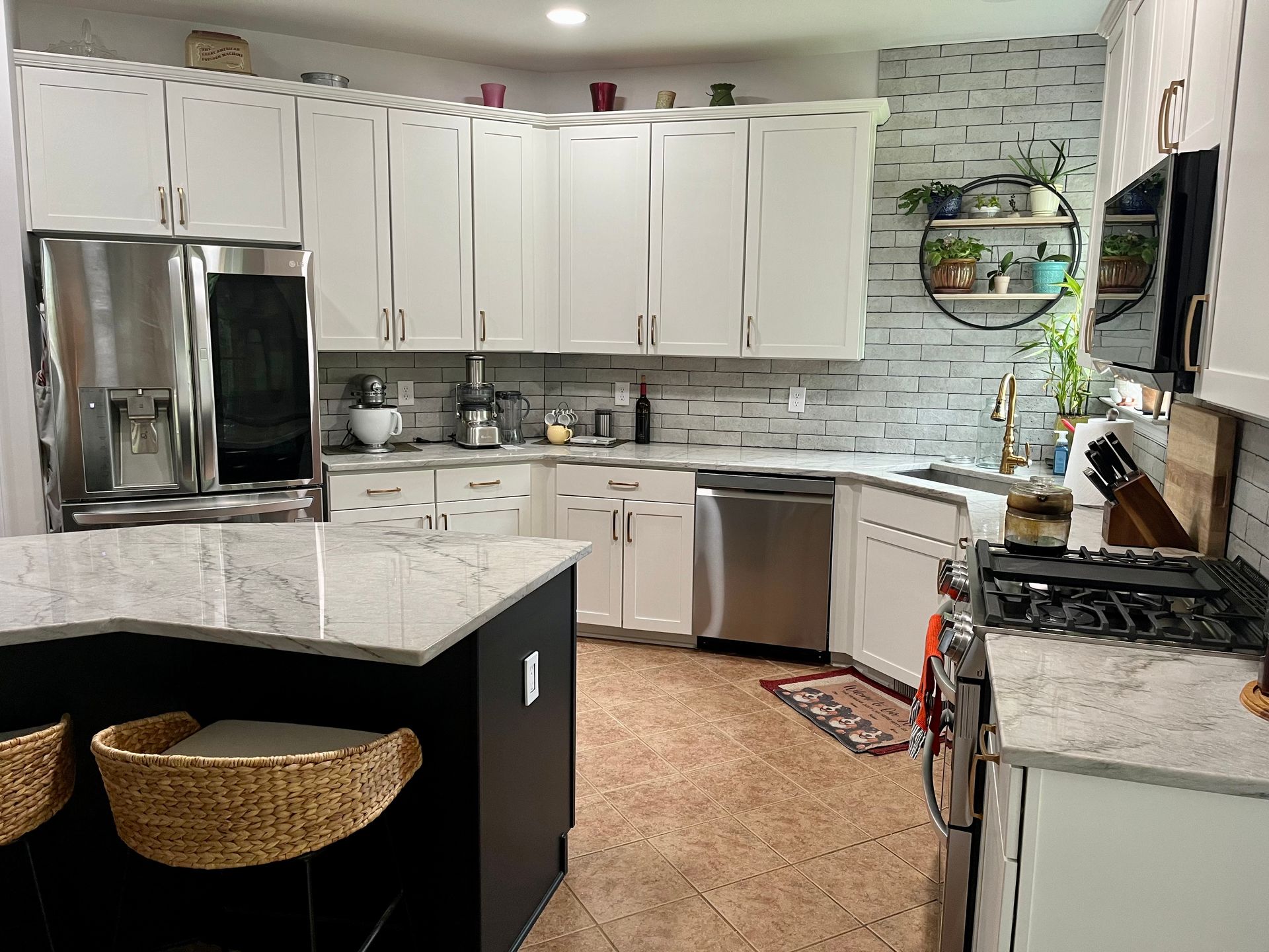 A kitchen with white cabinets and stainless steel appliances.