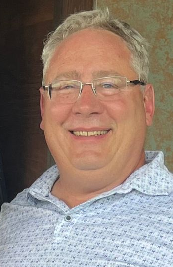 A man and a woman standing in front of a table that says a la carte
