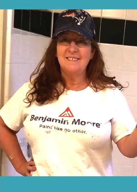 A woman wearing a benjamin moore t-shirt and a hat