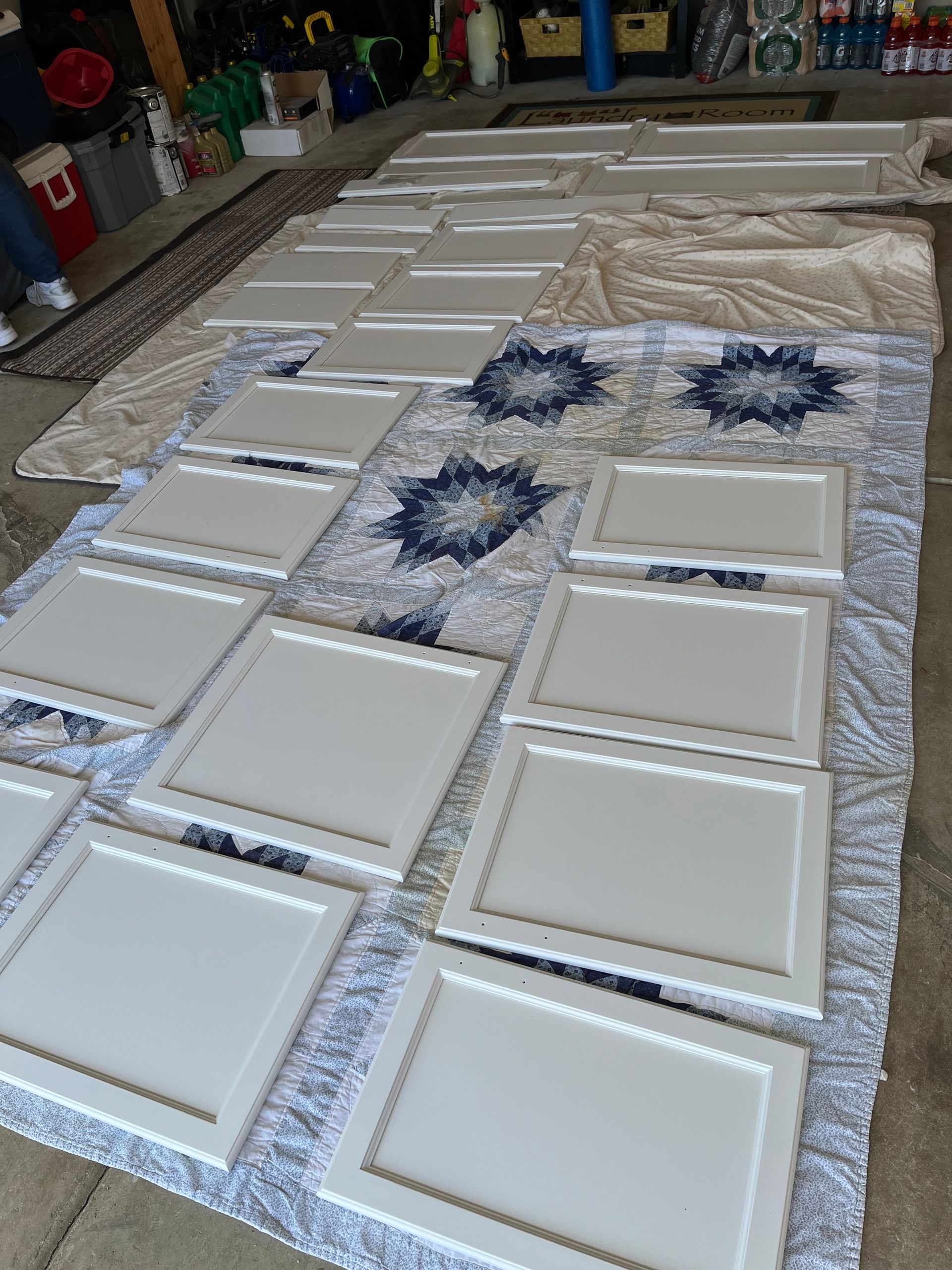 A bunch of white cabinet doors sitting on top of a table.