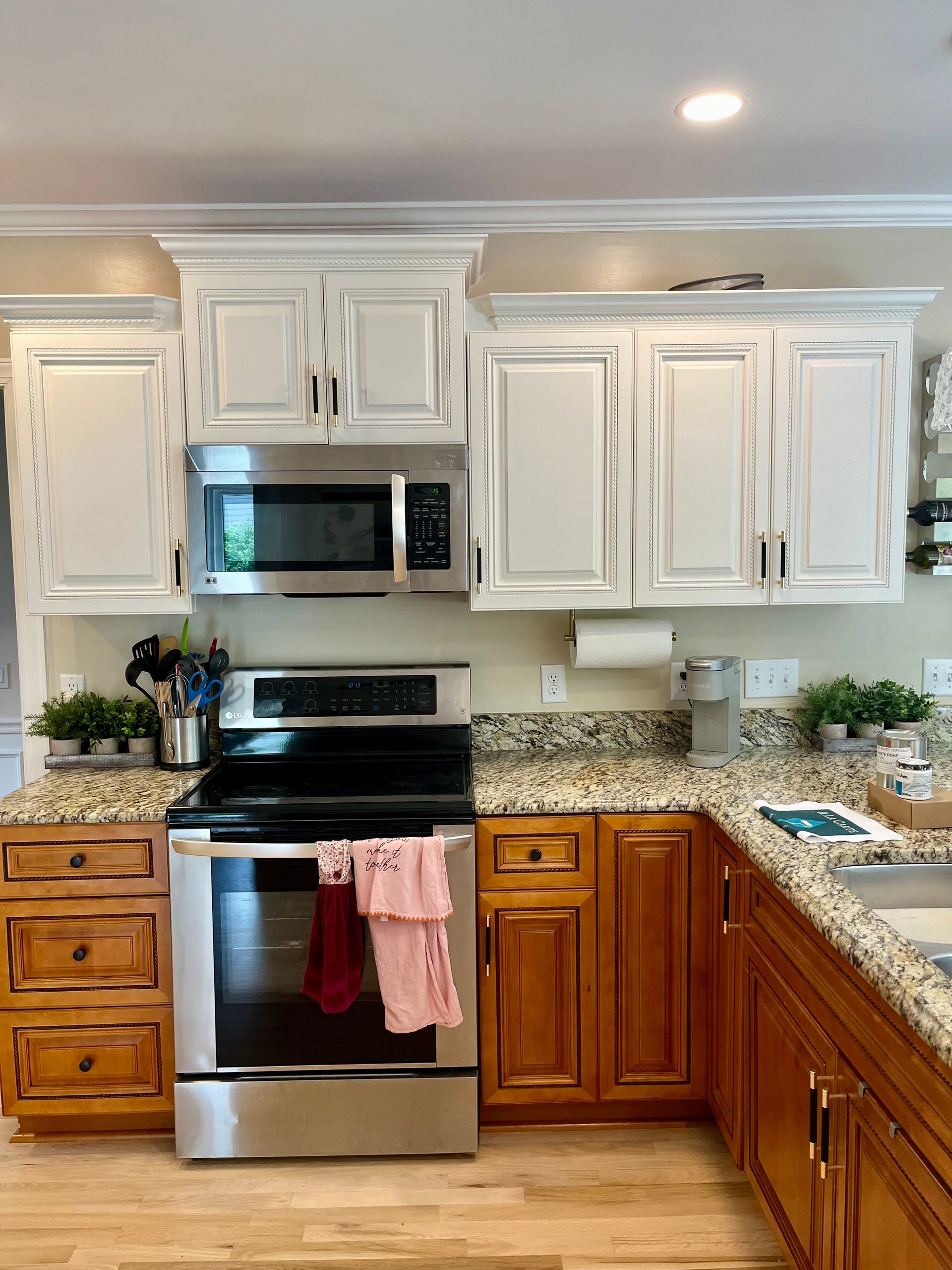 A kitchen with stainless steel appliances and wooden cabinets
