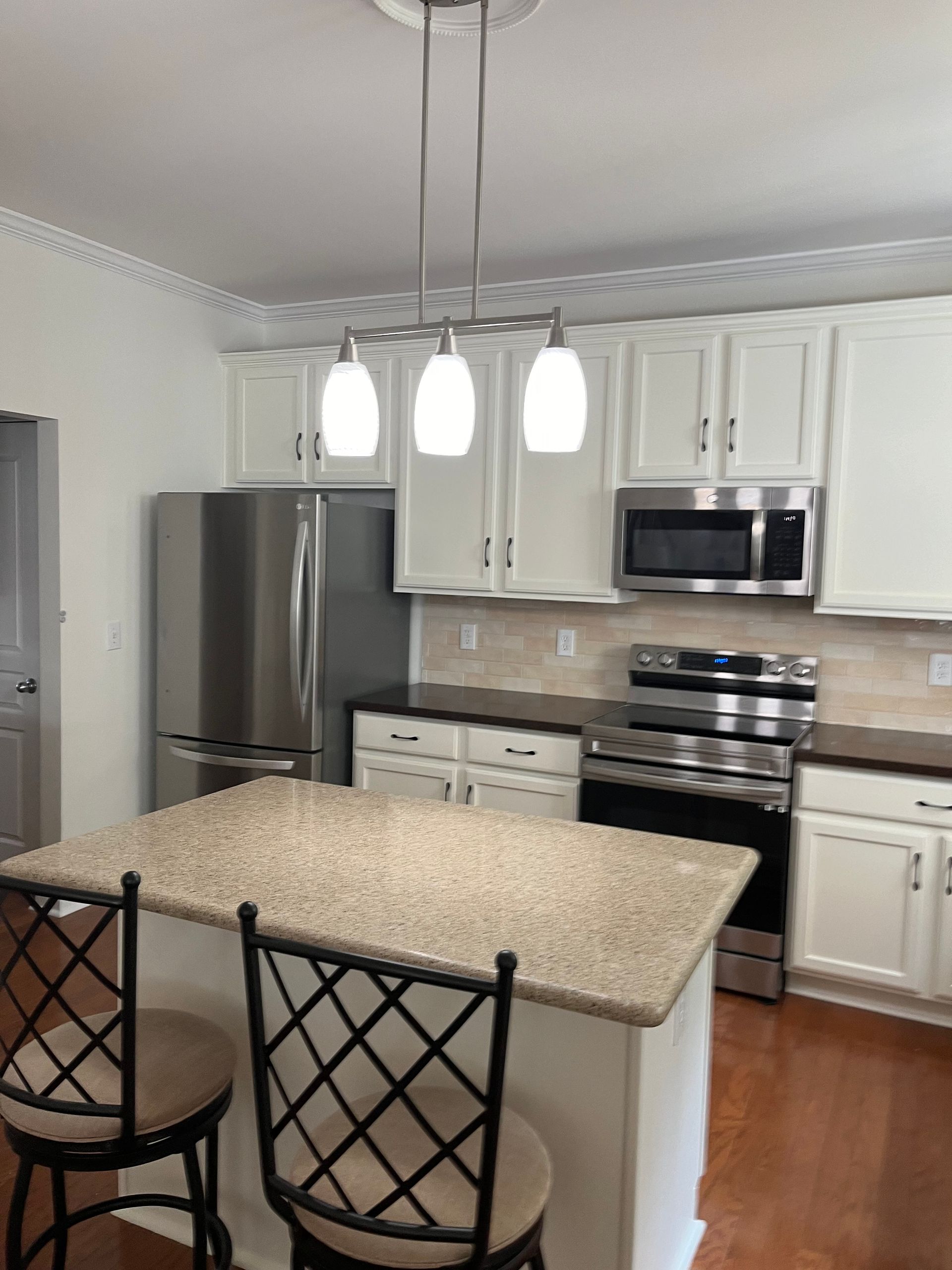 A kitchen with stainless steel appliances and granite counter tops