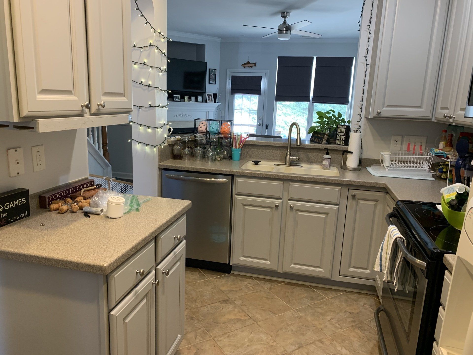 A kitchen with white cabinets and stainless steel appliances