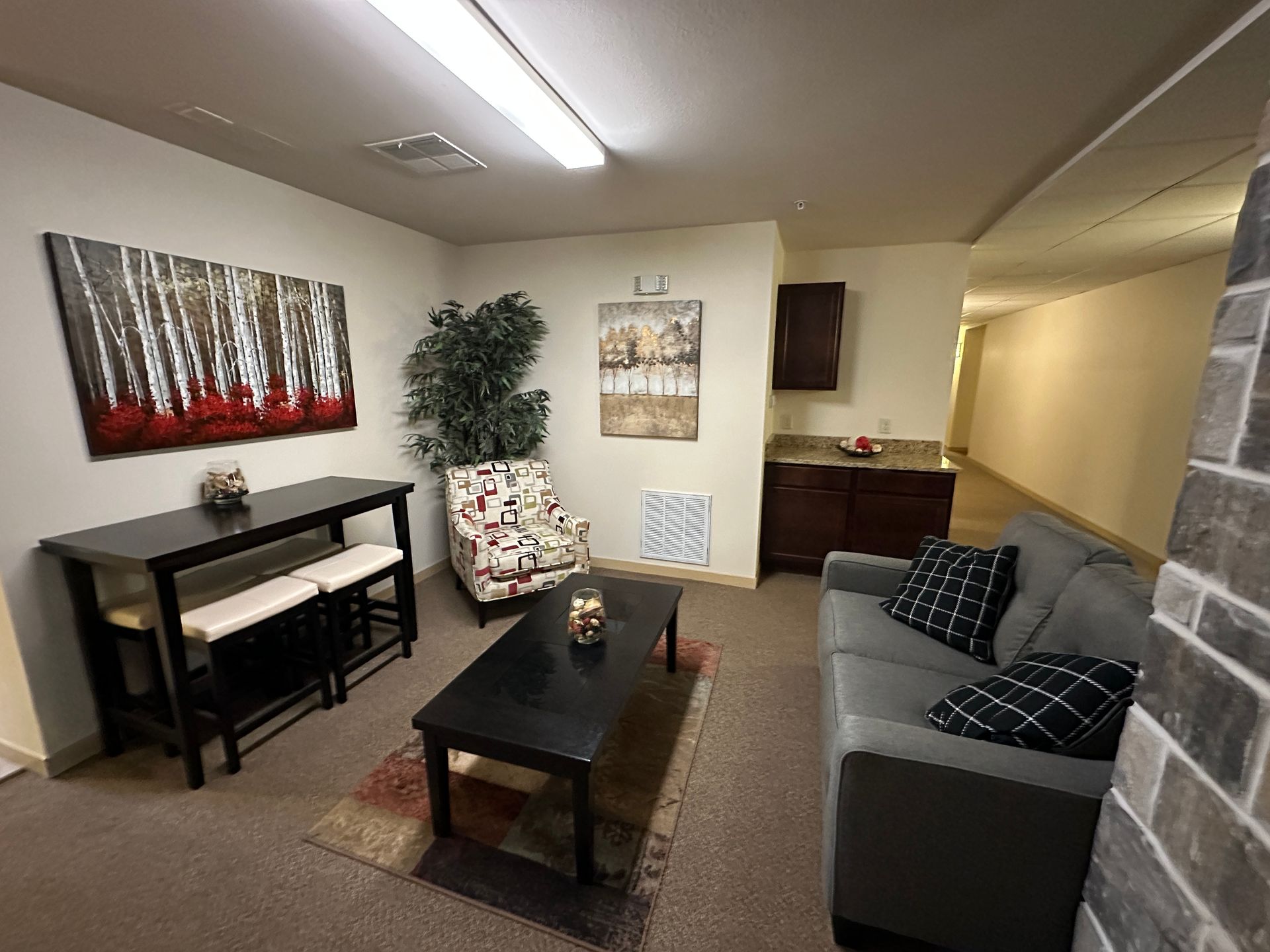 A living room with a couch , table and chairs