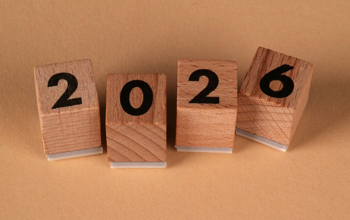 Wooden blocks spelling out the year 2026, set against a tan background.