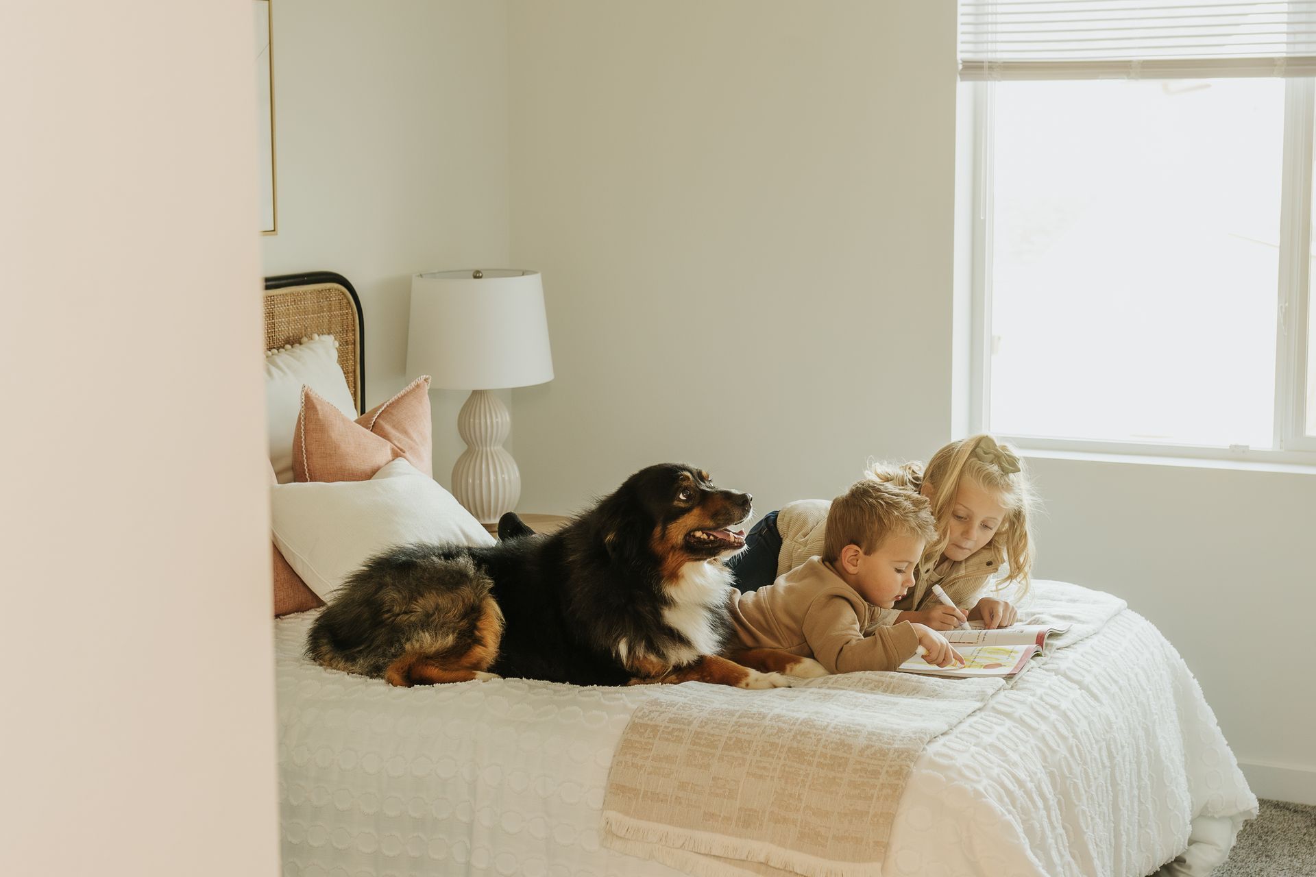Kids and dog at home on bed