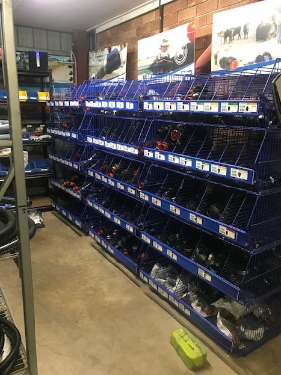A Warehouse Filled with Lots of Blue Bins Filled with Various Items — Yeppoon Stockfeed & Rural Supplies in Yeppoon, QLD