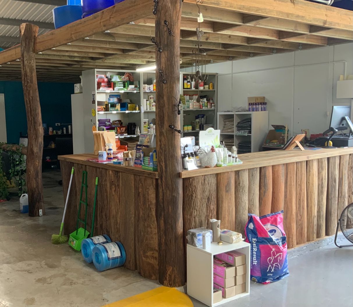 There Is a Wooden Counter in The Middle of The Room — Yeppoon Stockfeed & Rural Supplies in Yeppoon, QLD