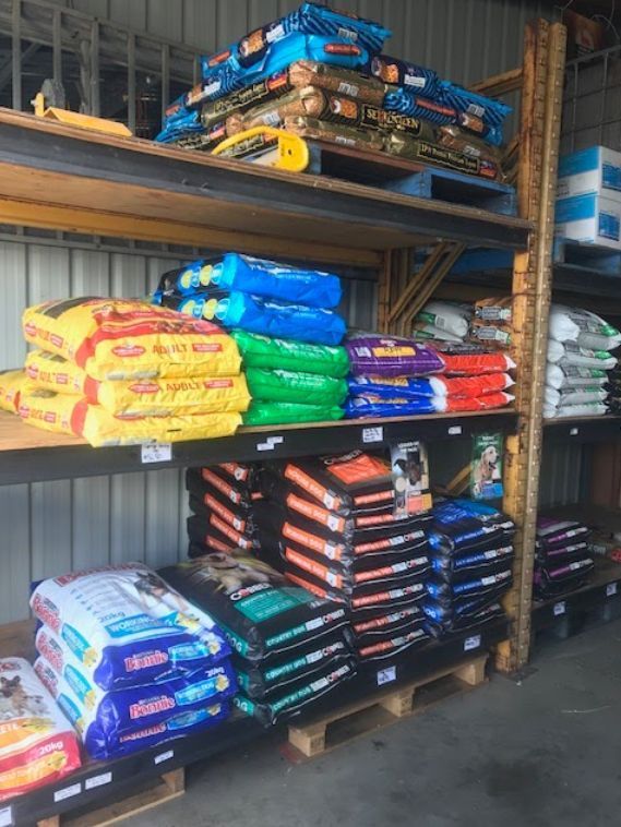 A Warehouse Filled with Lots of Bags of Dog Food — Yeppoon Stockfeed & Rural Supplies in Yeppoon, QLD