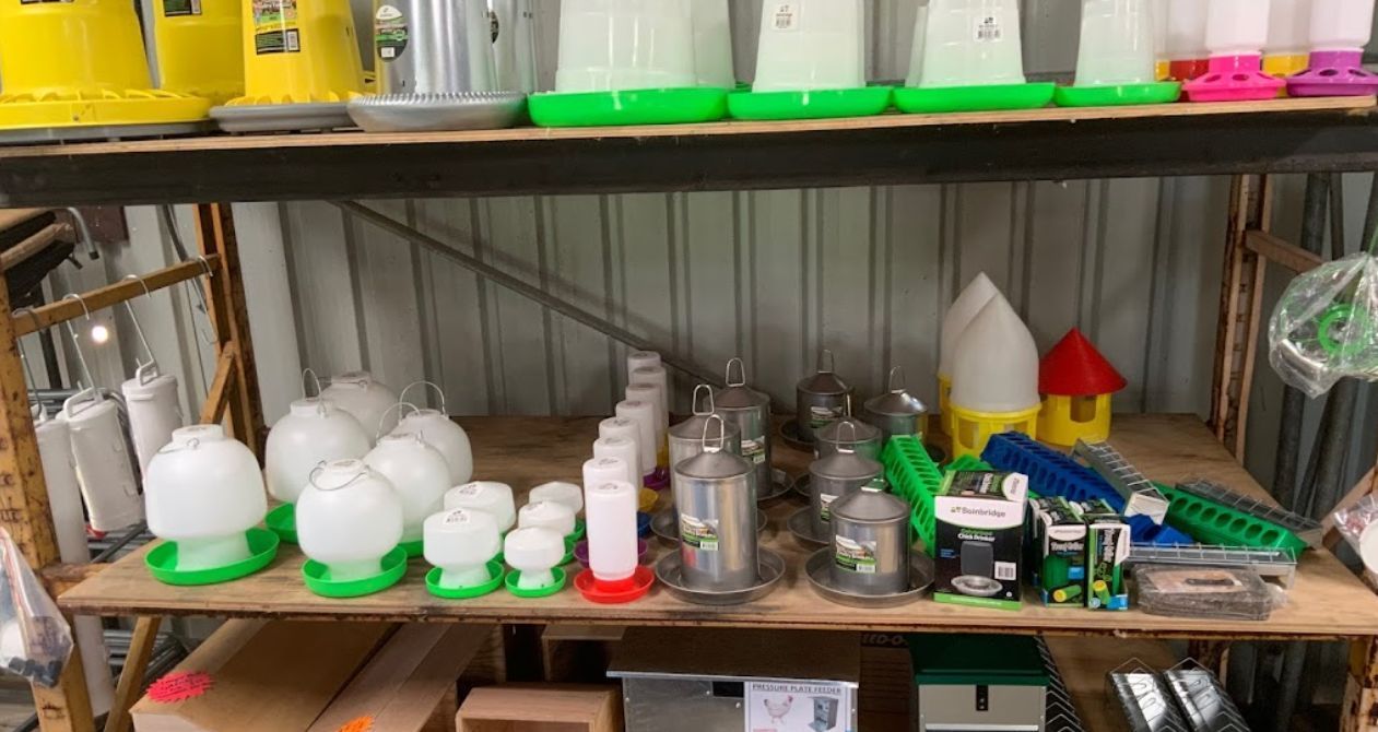 A Shelf Filled with Lots of Different Types of Chicken Feeders — Yeppoon Stockfeed & Rural Supplies in Yeppoon, QLD