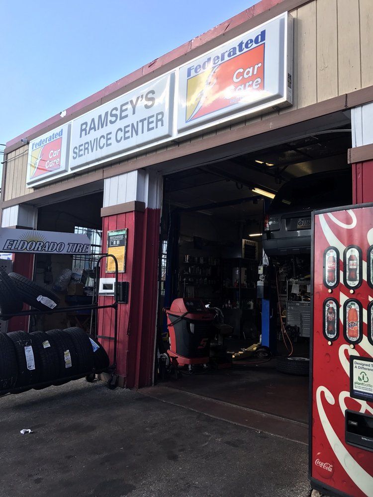 Ramsey's Service Center: A car repair shop with open garage door, tires, and Coca-Cola machine. | Ramsey's Service Center