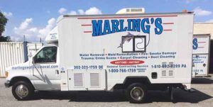 A white marling 's truck is parked in front of a building