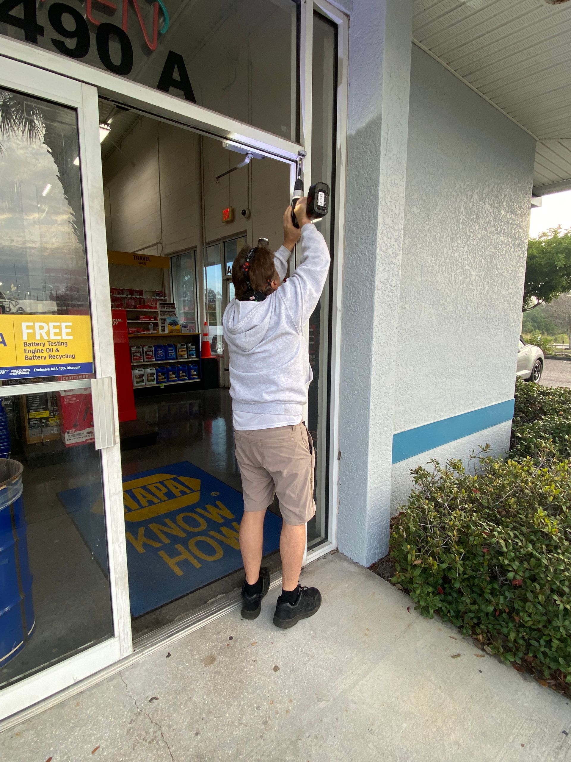 Piviot Hinges being replaced on a storefront door in Lakeland Florida