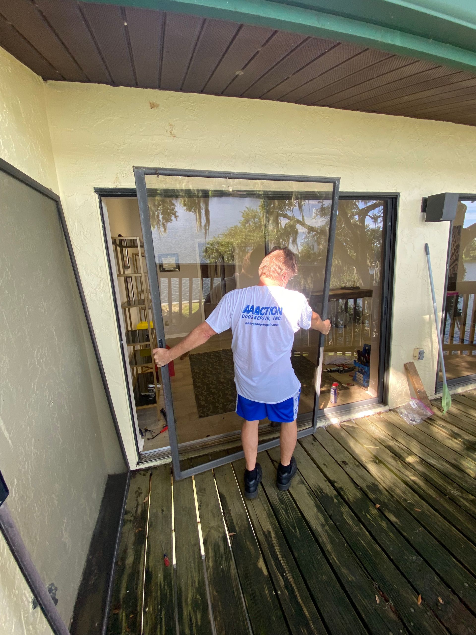Door Repair man fixing a sliding glass door. - Lakeland, FL - AA Action Door Repair