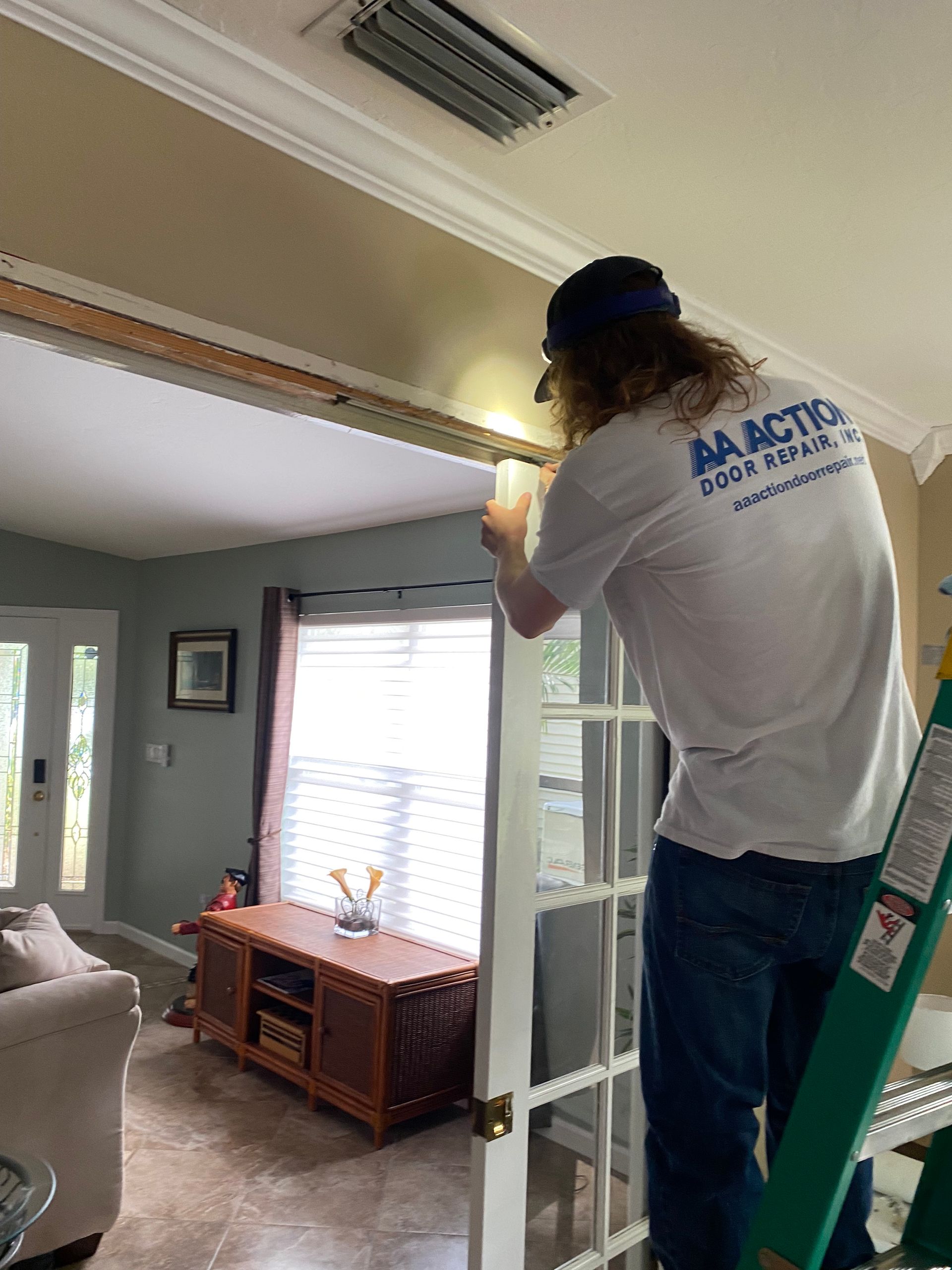 AA Action Door Repair tech repairing a broken pocket door in central Florida.
