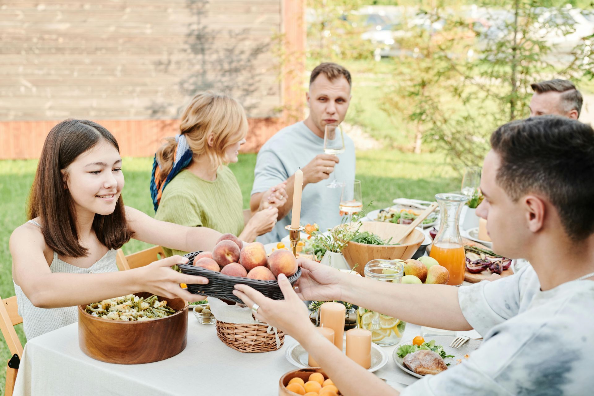A family of four having a picnic at a park.