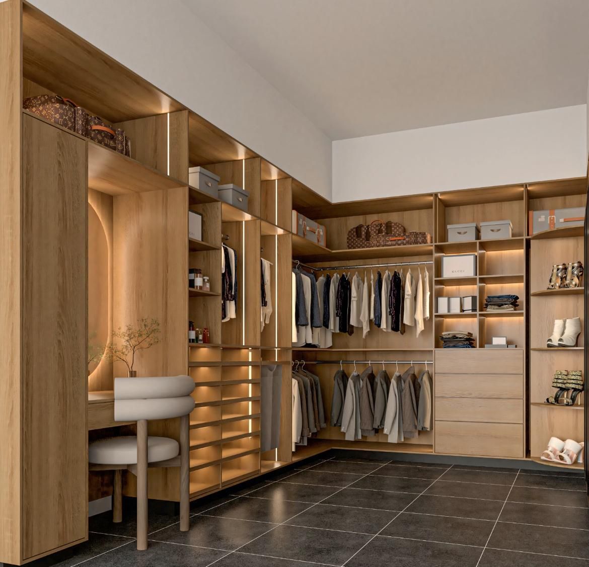 Vestidor con estanterías de madera, percheros, cajones y tocador. Suelo de baldosas oscuras y colores neutros.