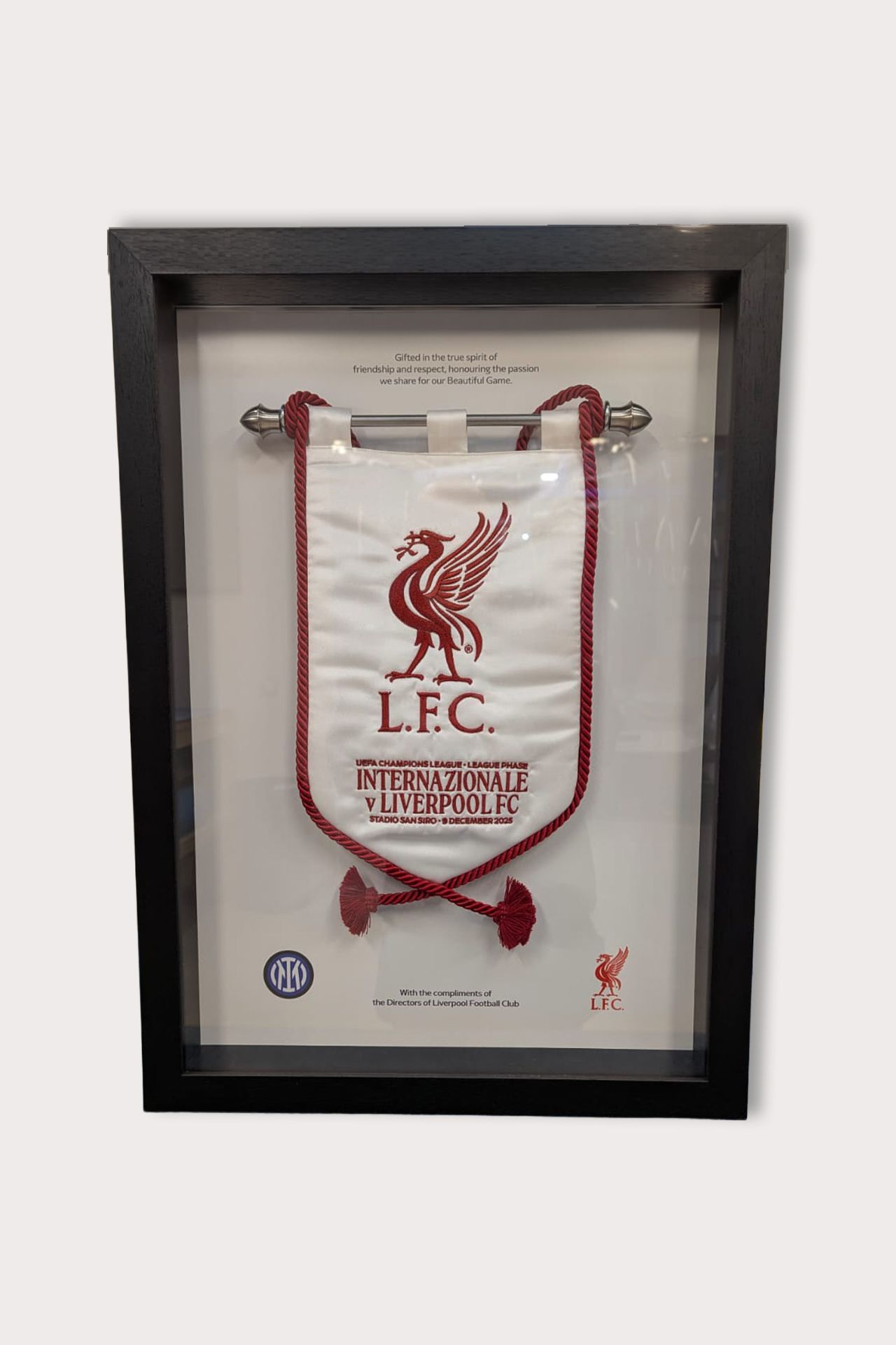 Framed Liverpool FC banner with the club's emblem in red and white.