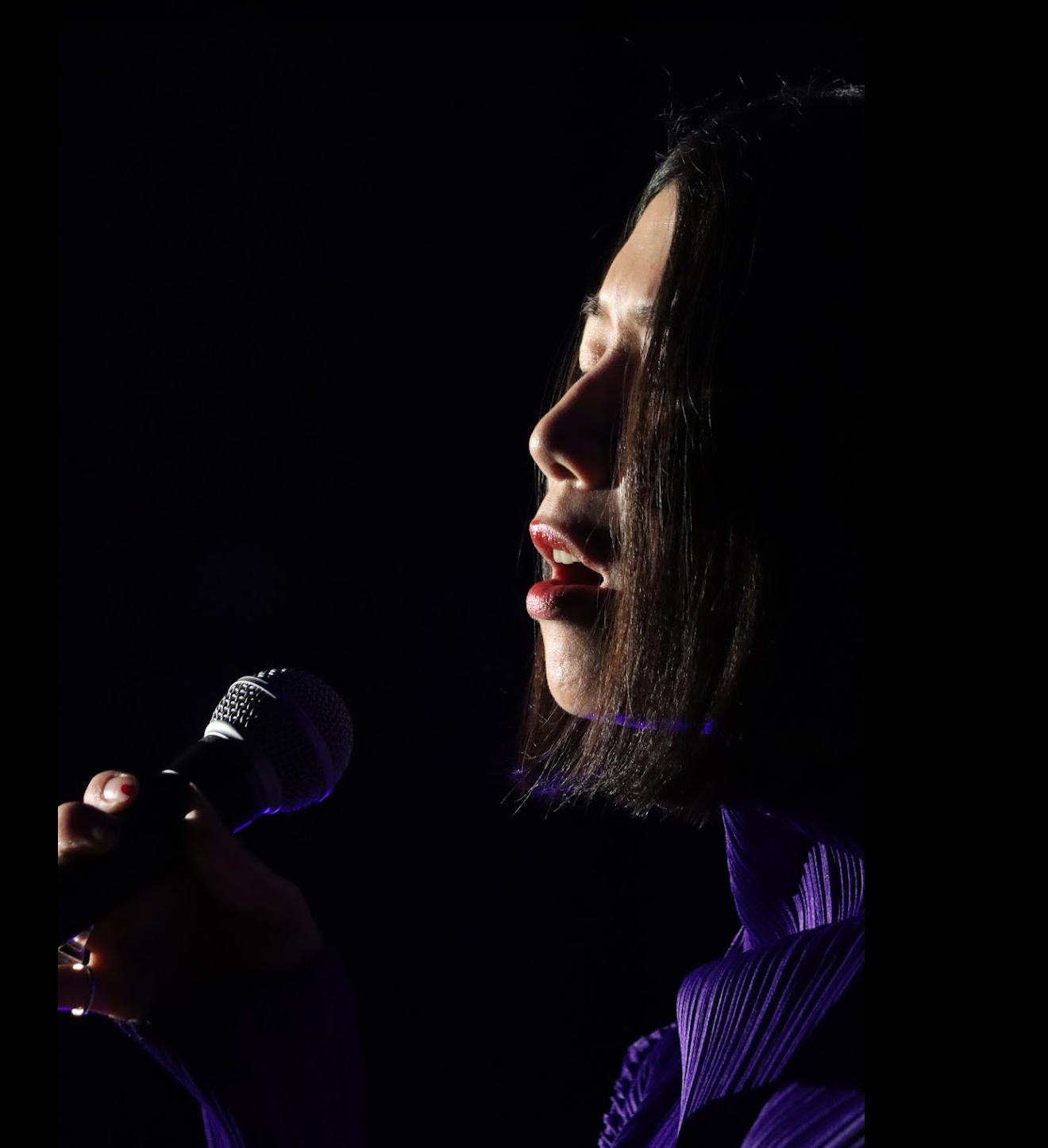 Man with short dark hair and goatee, wearing black shirt, looking at camera.