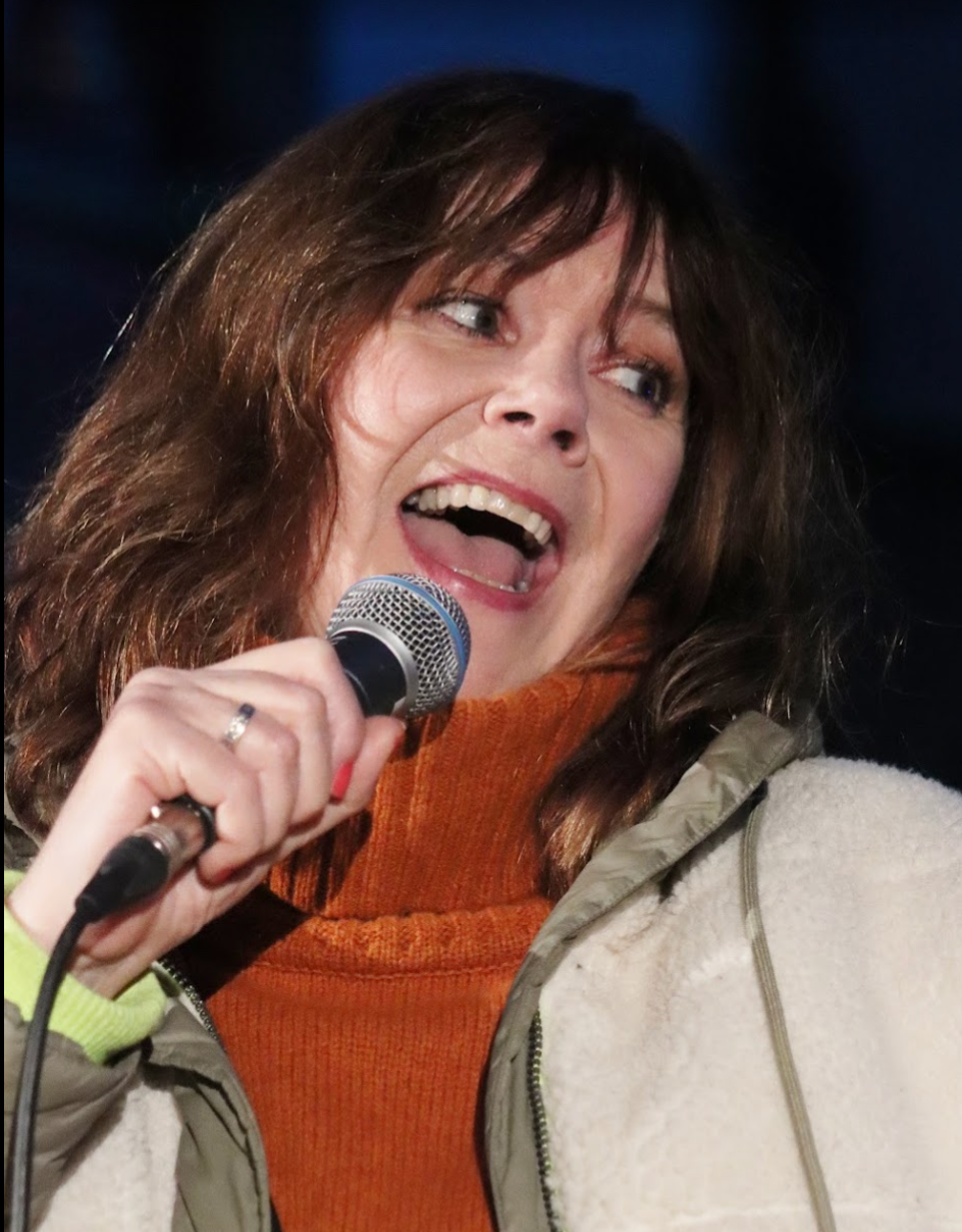 Man with short dark hair and goatee, wearing black shirt, looking at camera.