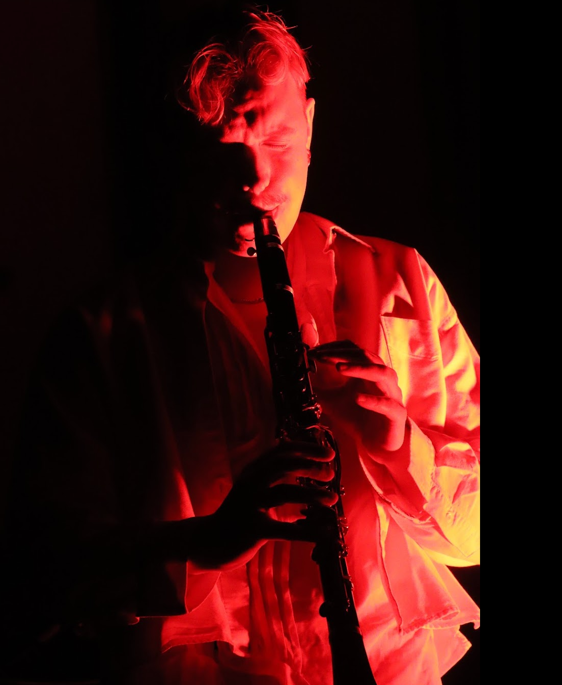 Man with short dark hair and goatee, wearing black shirt, looking at camera.