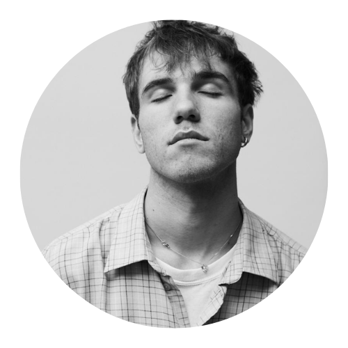 Man with short dark hair and goatee, wearing black shirt, looking at camera.