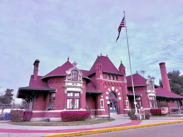 A large red brick building with a flag flying in front of it in Nampa